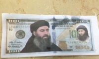 العثور أوراق نقدية عليها صور وكتابات لداعش 